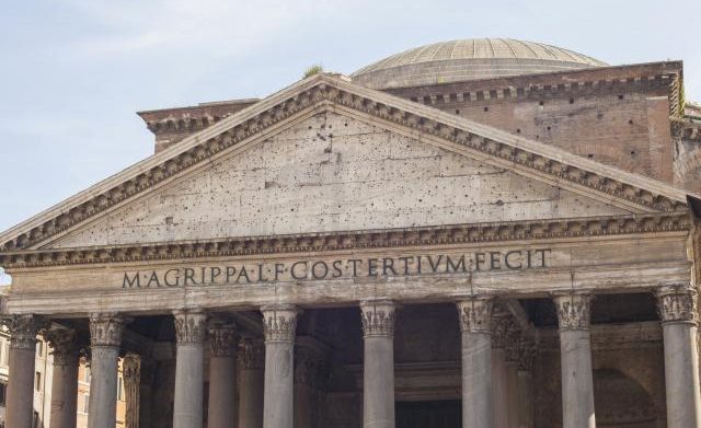 Roman style architecture: Building with Corinthian columns and text engraved on the apex facet